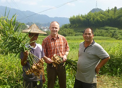 Seeberger buyer with suppliers holding root ginger